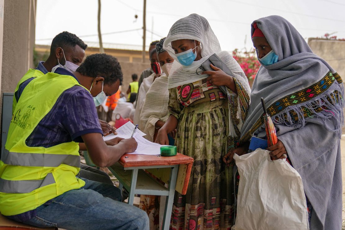 People line up to receive relief aid packages at an operation run by USAID, Catholic Relief Services and the Relief Society of Tigray on June 16, 2021 in Mekele, Ethiopia.