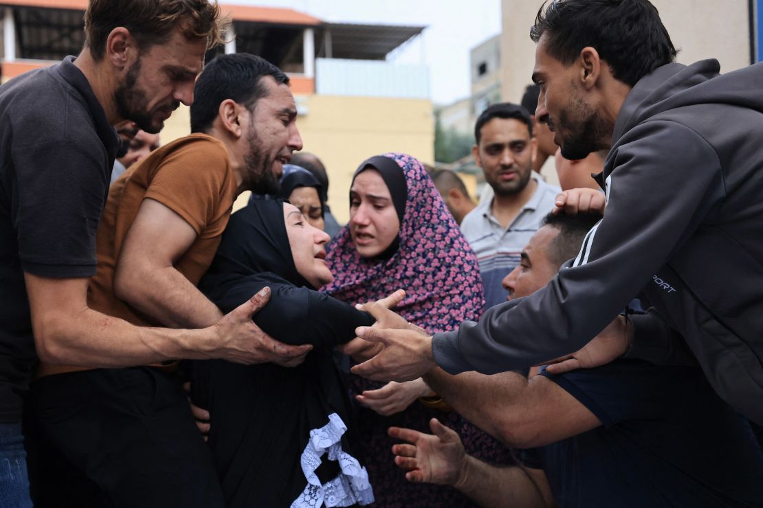 Palestinians mourn the death of their relatives following an Israeli airstrike on the refugee camp of Jabalia in the Gaza Strip on October 9, 2023.