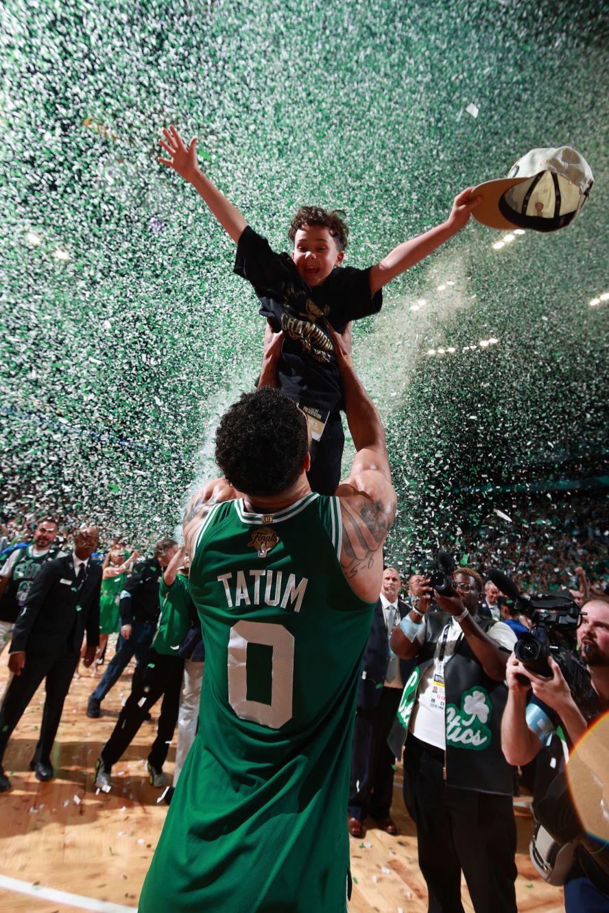Boston Celtics star Jayson Tatum lifts his son, Deuce, after the <a href="index.php?page=&url=https%3A%2F%2Fwww.cnn.com%2F2024%2F06%2F17%2Fsport%2Fnba-finals-celtics-mavericks-game-5-spt-intl%2Findex.html">Celtics won the NBA championship</a> on Monday, June 17. The Celtics defeated the Dallas Mavericks in five games to secure their league-record 18th title.