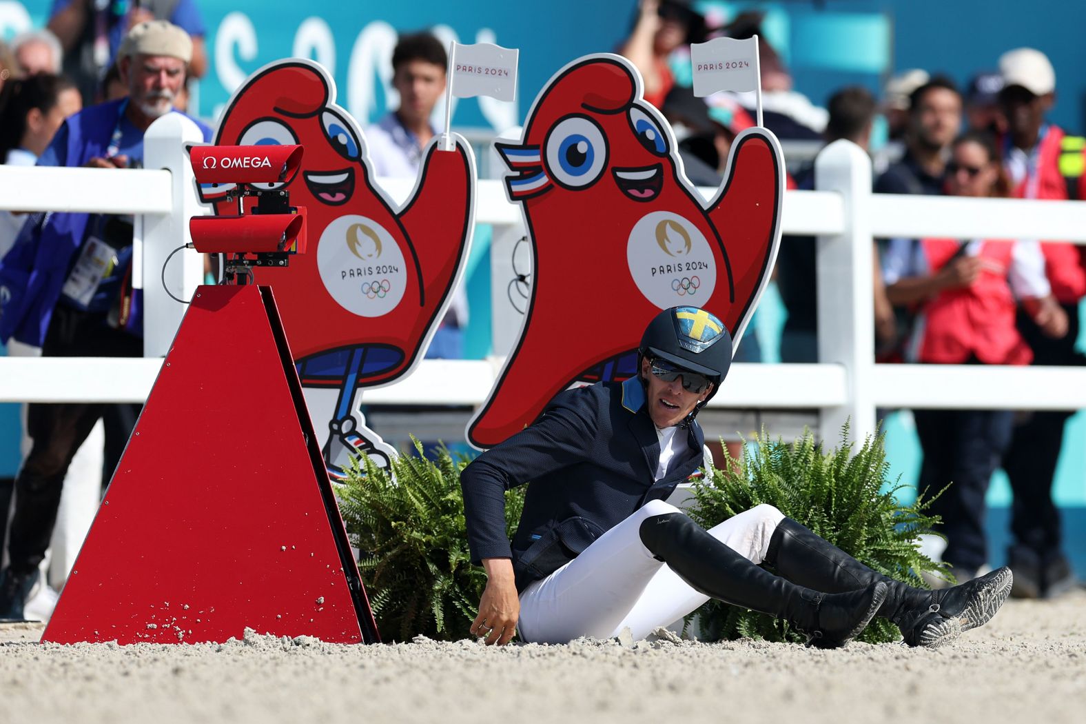 Sweden's Henrik von Eckermann sits on the ground after falling off his horse during an equestrian event on August 6.