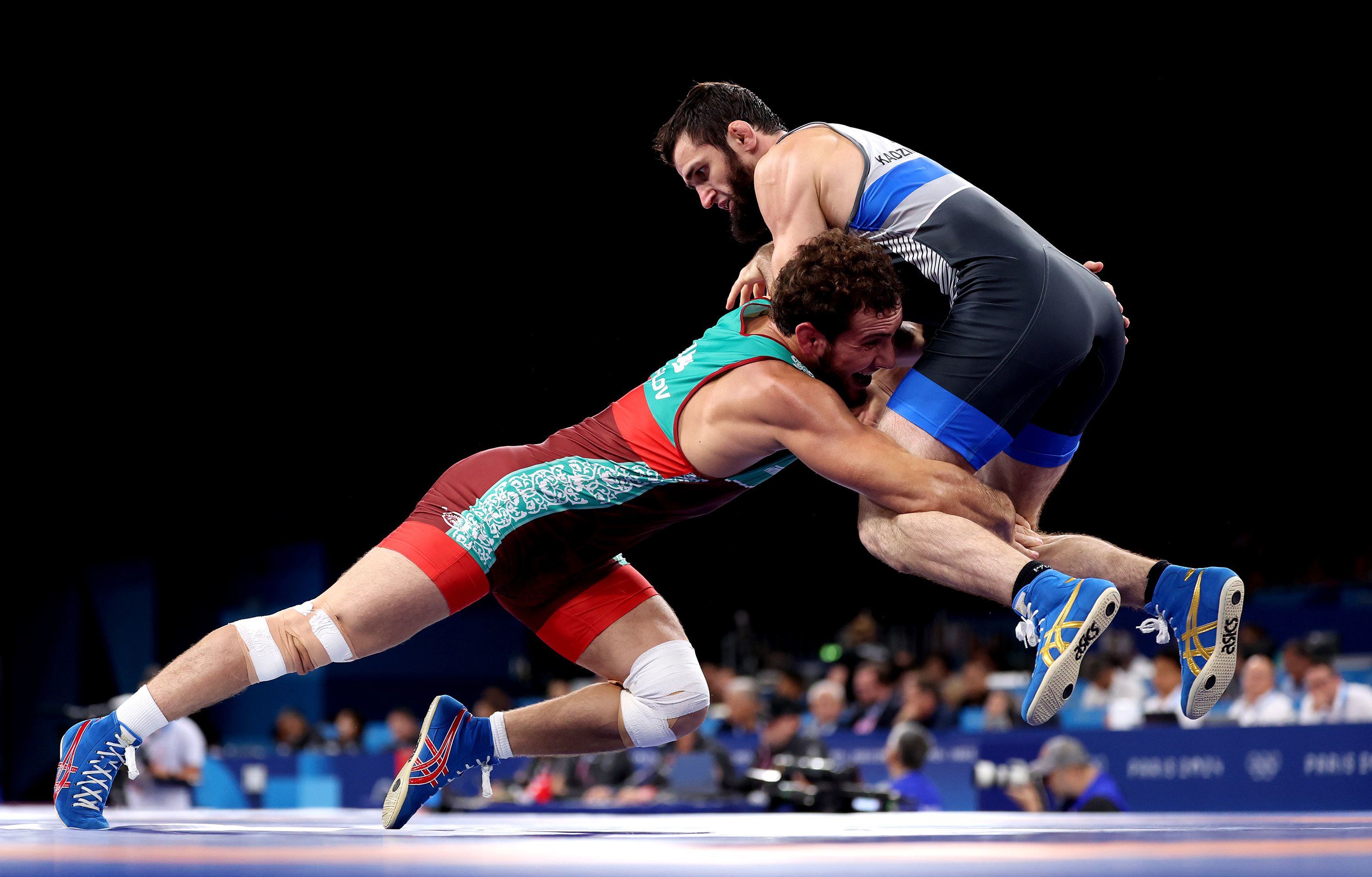 Uzbekistan's Razambek Zhamalov, left, wrestles Mahamedkhabib Kadzimahamedau, a member of the neutral athletes team, on August 9. Amid the <a href="https://www.cnn.com/world/europe/ukraine">ongoing war in Ukraine</a>, the International Olympic Committee <a href="https://www.cnn.com/2023/12/08/sport/russian-belarusian-athletes-olympics-paris-2024-spt-intl/index.html">announced in December</a> that Russian and Belarusian athletes would only be eligible to compete as individual neutral athletes at this year’s Olympics.