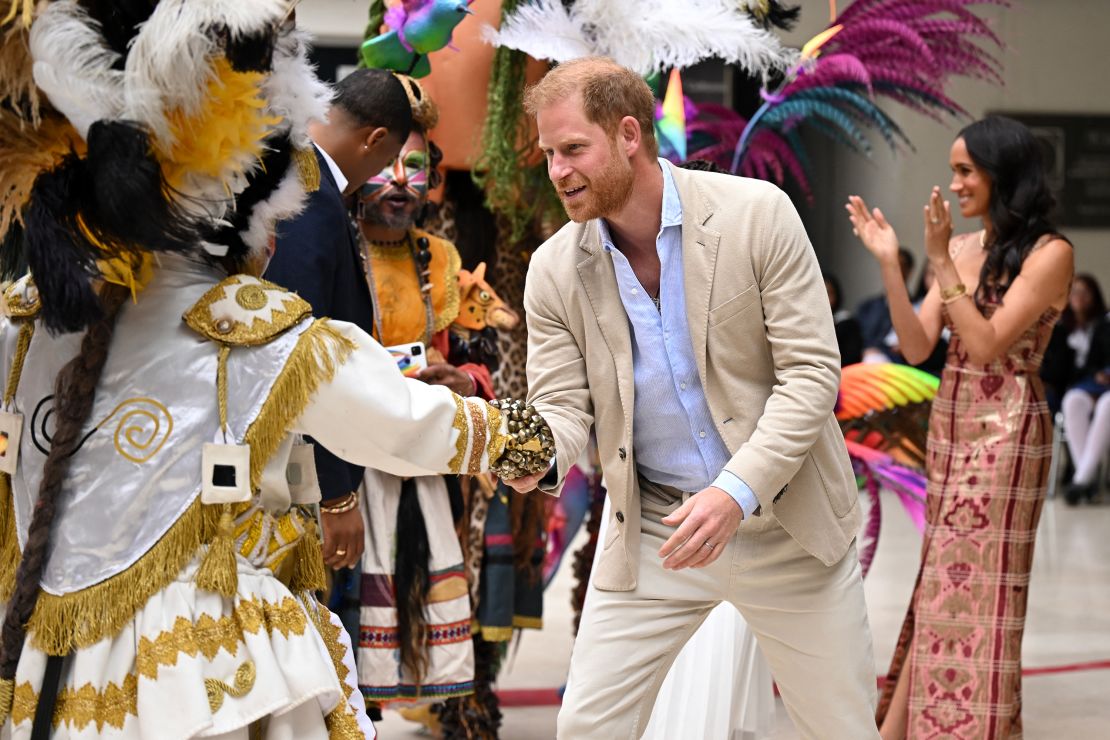 Prince Harry greets an artist, next to his wife, Meghan, during a visit to the National Center for the Arts in Bogotá on August 15.