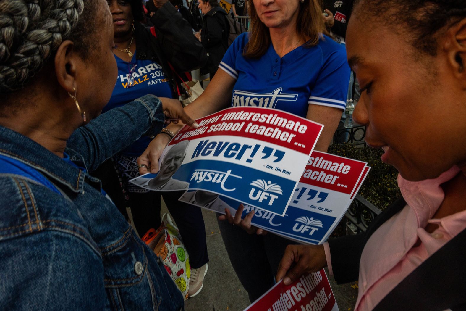 Members of the United Federation of Teachers rally at the debate site to show their support for Walz.