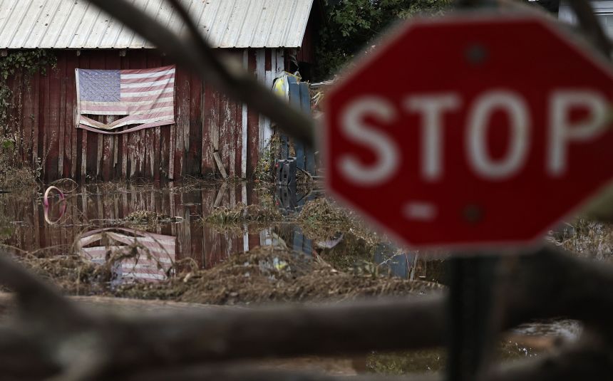 An American flag is reflected in floodwaters from Hurricane Helene in Swannanoa, North Carolina, on October 4, 2024.
