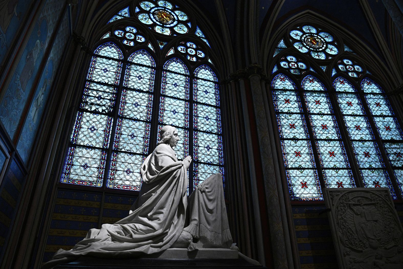 A sculpture of Archbishop Sibour is seen next to a stained glass window on December 8.