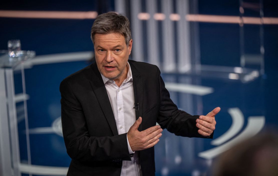 Green Party's candidate for chancellor Robert Habeck gestures as he talks with citizens during the TV program 