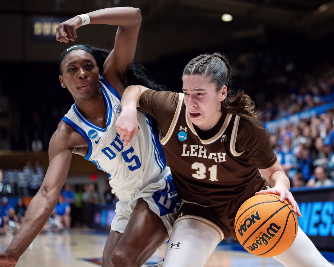 Colleen McQuillen of the Lehigh Mountain Hawks drives to the basket while guarded by Oluchi Okananwa of the Duke Blue Devils.