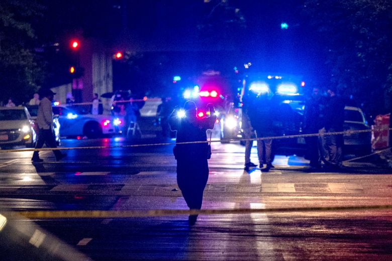 FBI agents and police officers work outside the Capital Jewish Museum following the shooting of Lischinsky and Milgrim, in the early hours of May 22.