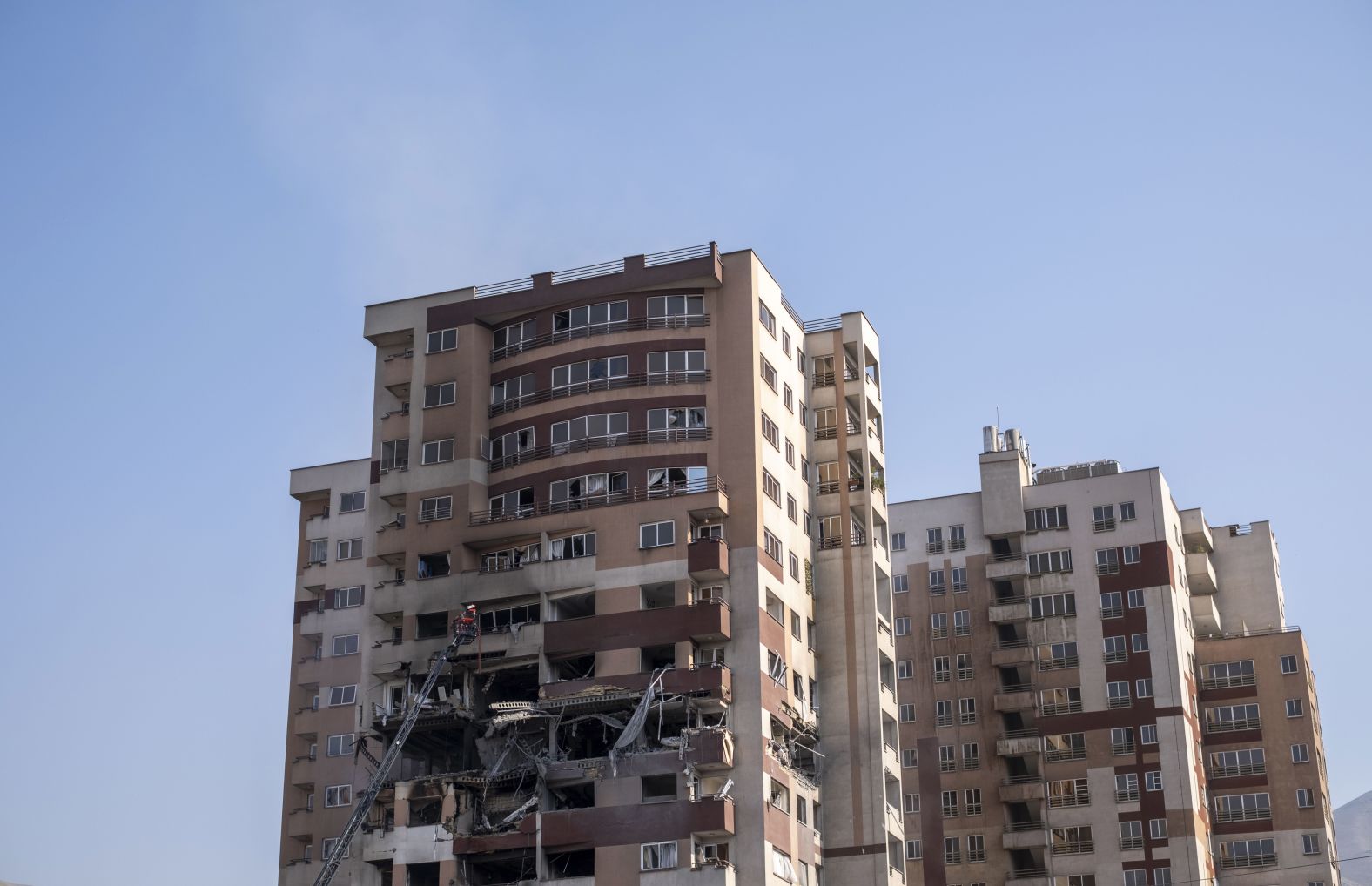 Emergency workers inspect a residential complex that was damaged in Tehran.