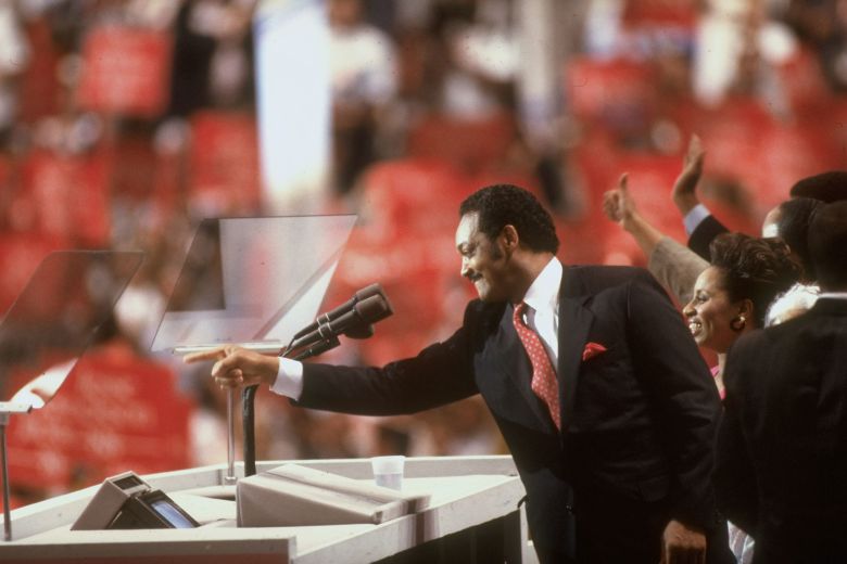 Jesse Jackson addresses the Democratic National Convention alongside his wife Jackie.