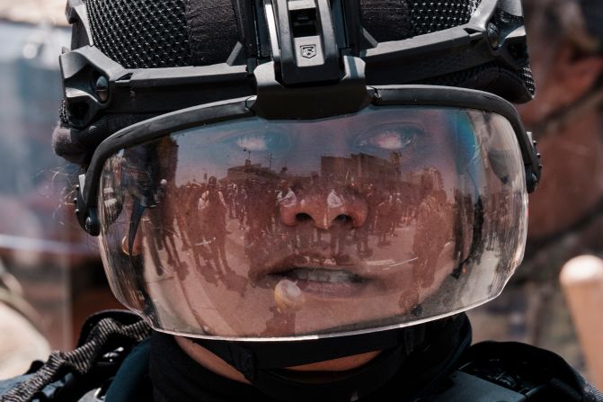 Protesters are reflected by a federal agent’s helmet visor in downtown Los Angeles on Sunday, June 8.