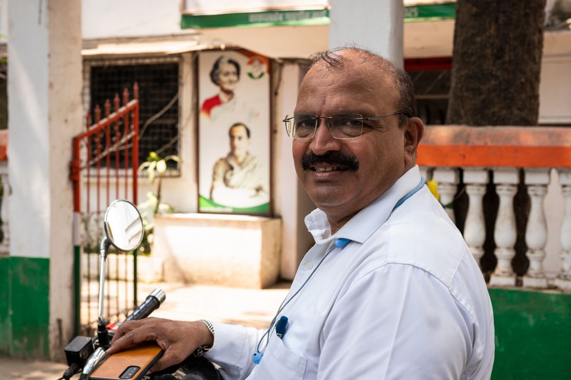Sanjay Sardesai sits on his motorbike outside of the Indian National Congress headquarters during an interview with CNN in Mumbai, India, on April 16, 2024.