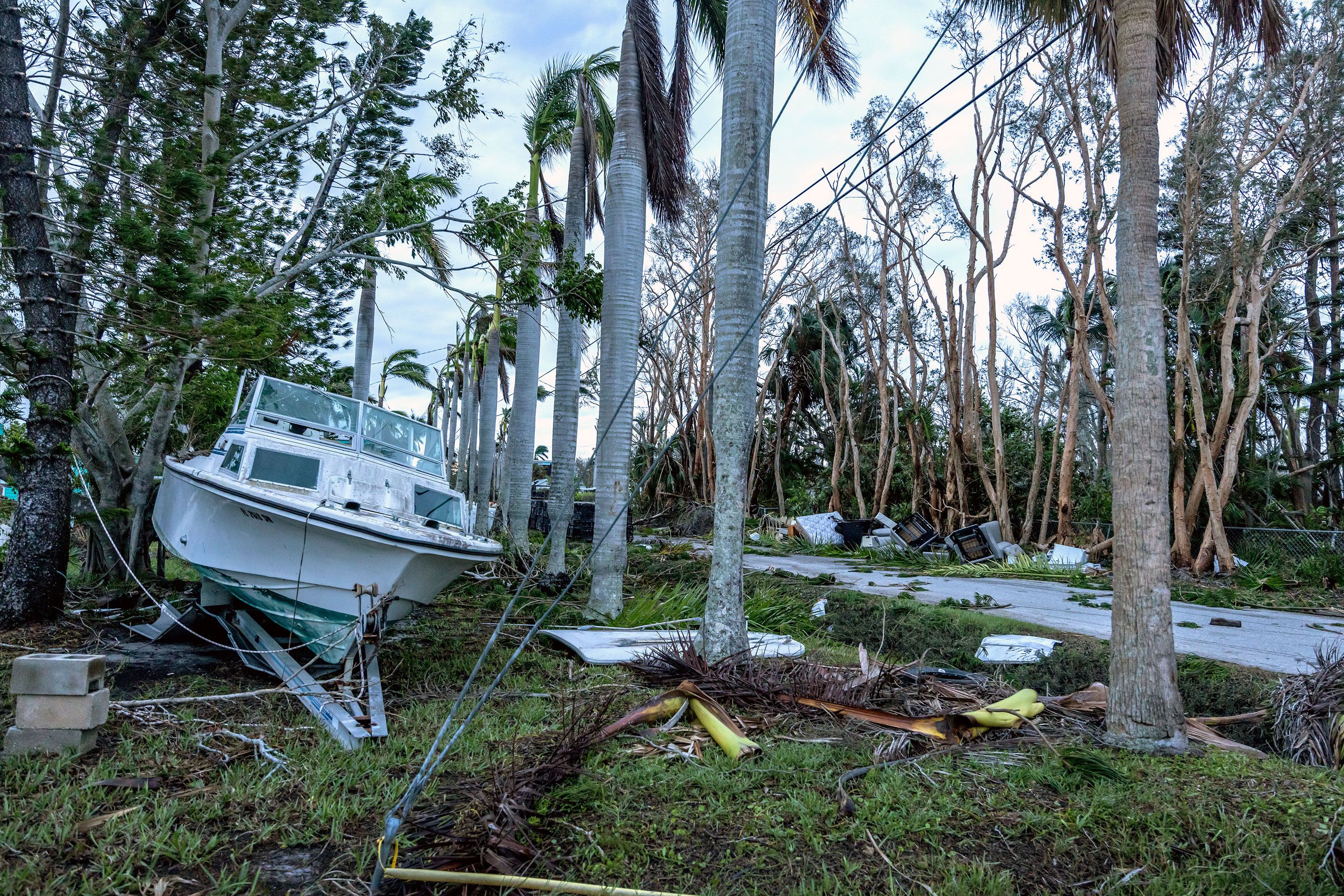 A boat and debris are seen along a road in Bradenton, Florida, on Thursday.