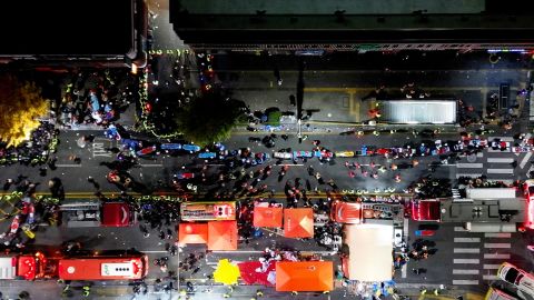 Emergency personnel work at the scene at the popular Itaewon district in Seoul on October 30.