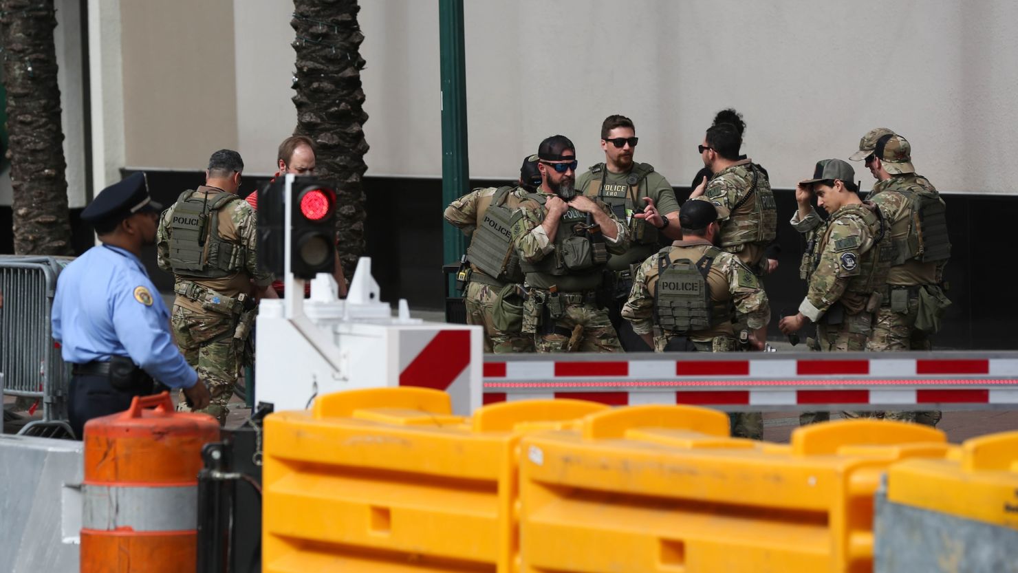 Law enforcement officials are seen along Canal Street in New Orleans on Monday.