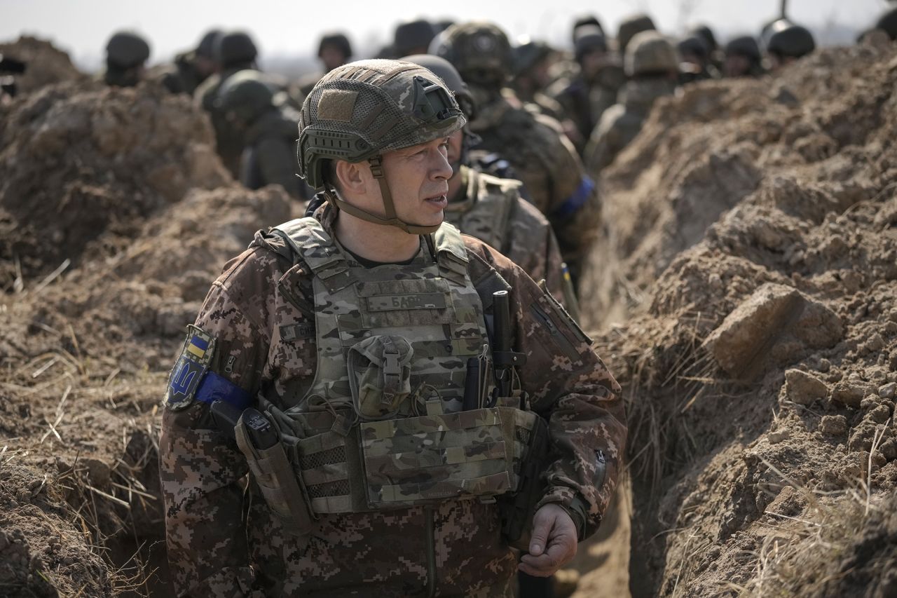 Col. Gen. Oleksandr Syrskyi walks in a trench at a position north of the capital Kyiv, Ukraine, on March 29, 2022.