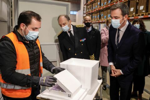 French Health Minister Olivier Véran, right, looks at a box containing the Pfizer/BioNTech Covid-19 vaccine while visiting a distribution center in Chanteloup-en-Brie, France, on December 22.