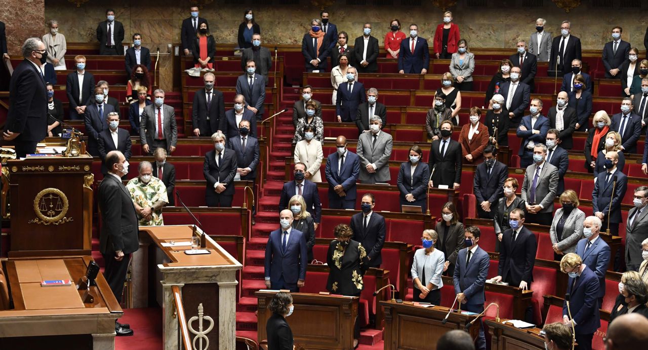 French Prime Minister Jean Castex (second from left, behind the lower desk) leads lawmakers in a moment of silence at the National Assembly in Paris on Thursday, in tribute to the victims of a knife attack in Nice.