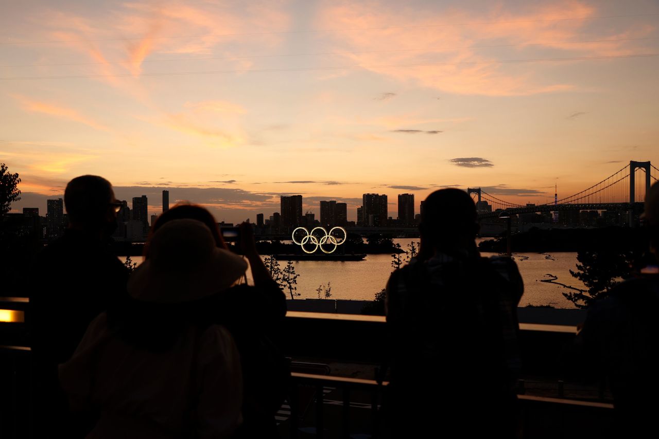 People take photos of the Olympic rings displayed at Odaiba Marine Park in Tokyo on July 19.