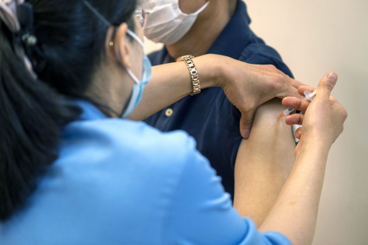 A nurse administers a Covid-19 vaccine at a community vaccination center in Hong Kong, on February 26. 