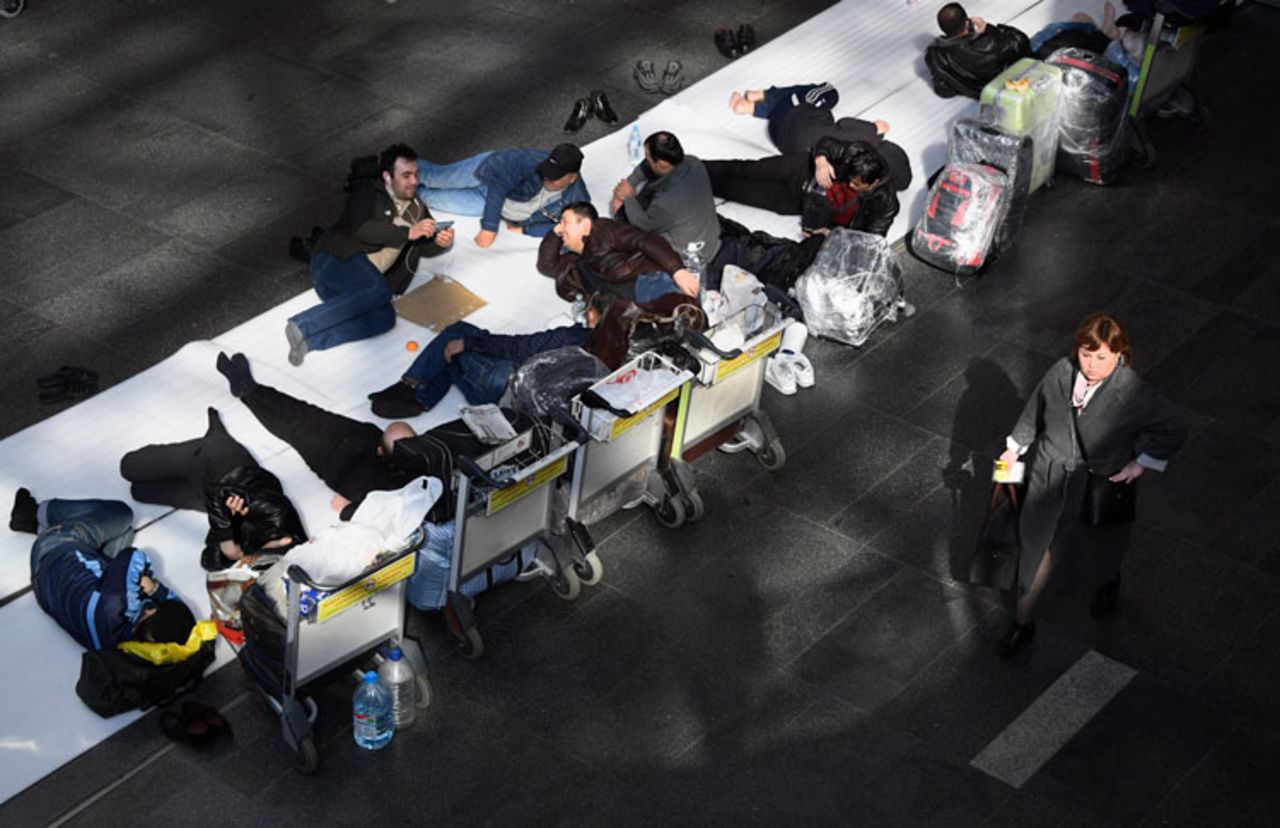 People sit stuck at Moscow's Vnukovo airport on March 24 after neighboring countries closed borders and stopped flights.