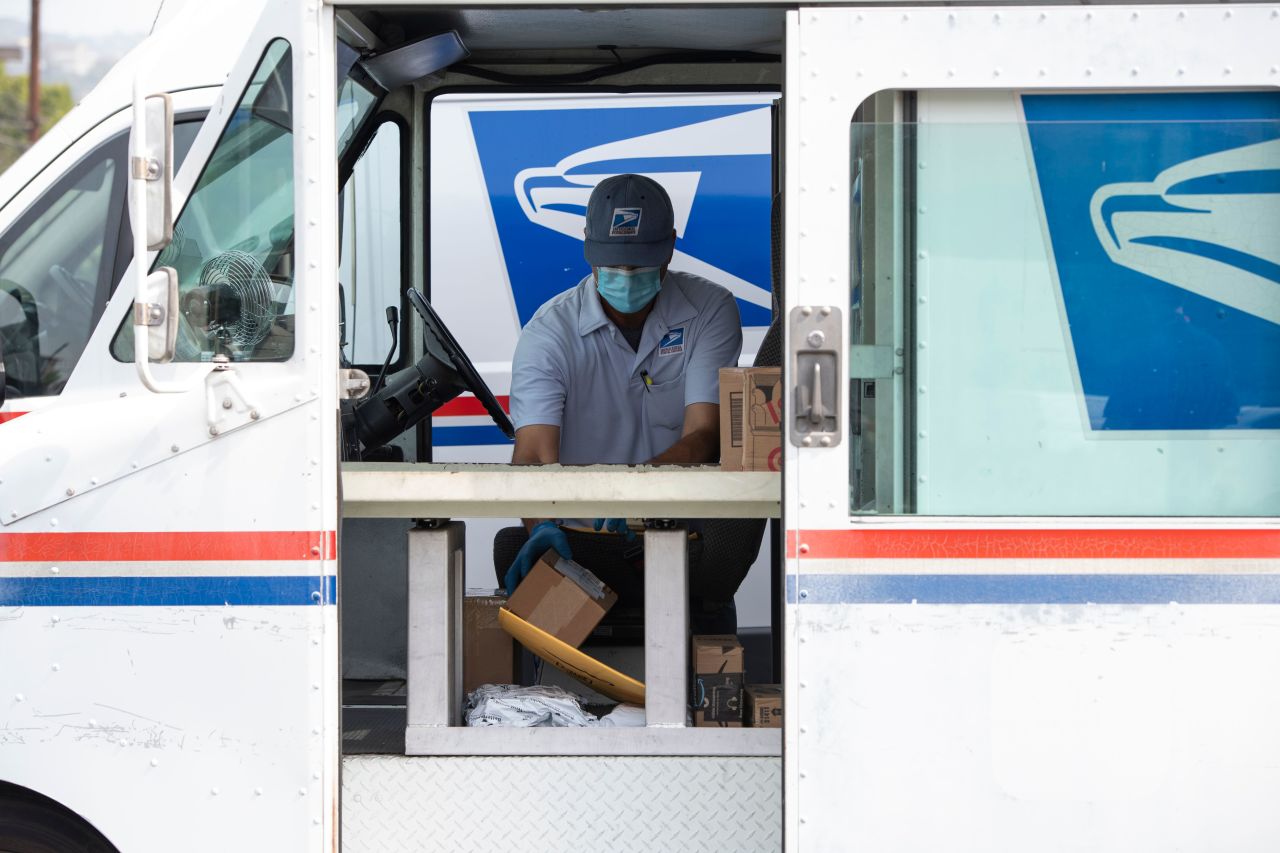 A US Postal Service employee delivers mail in Los Feliz, a neighborhood in Los Angeles, on April 29.