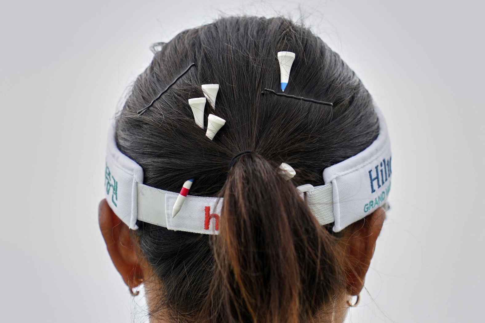Tees are pinned in the hair of Lydia Ko of New Zealand during the third round of the Women's British Open golf championship in Porthcawl, Wales, on Saturday, August 2.