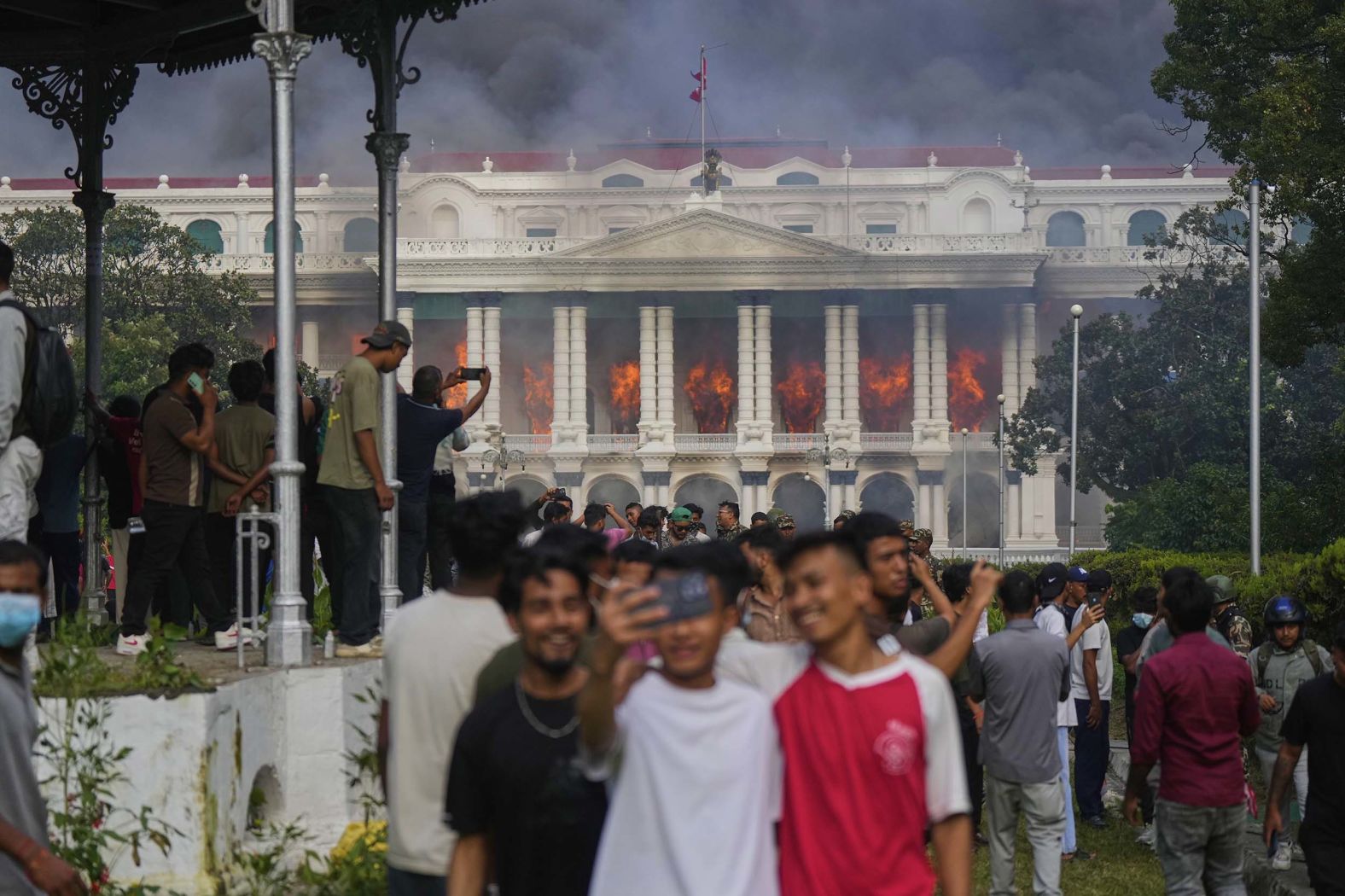 People take selfies and celebrate at the Singha Durbar, the seat of Nepal's government's various ministries and offices, after it was set on fire during a <a href="index.php?page=&url=https%3A%2F%2Fwww.cnn.com%2F2025%2F09%2F09%2Fasia%2Fnepal-protests-social-media-ban-explainer-intl-hnk">protests in Kathmandu</a> on Tuesday, September 9. Nepali protesters, angered by a bloody crackdown, defied a police curfew and took over the streets of the capital on Tuesday, setting fire to the Supreme Court, parliament and other government buildings. Nepali Prime Minister KP Sharma Oli announced his resignation on Tuesday.