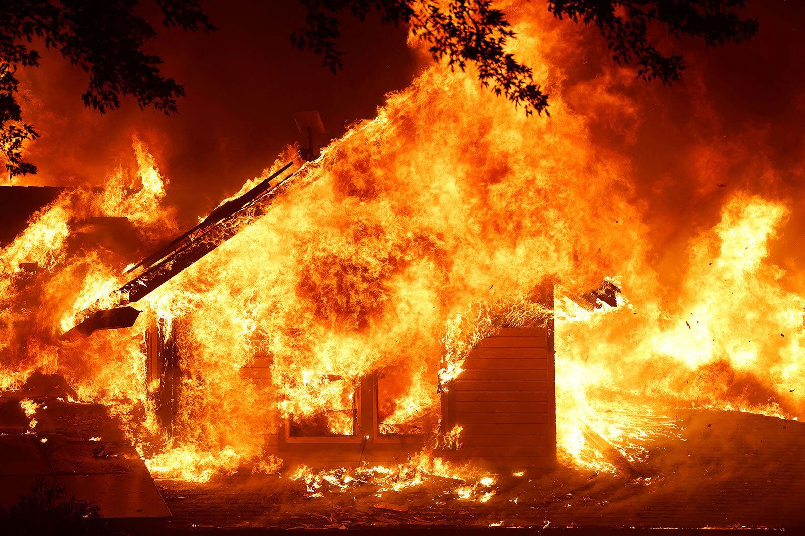 A house near Chico, California, burns from the Park Fire on Thursday, July 25. The massive wildfire has forced mandatory evacuations in Butte County.