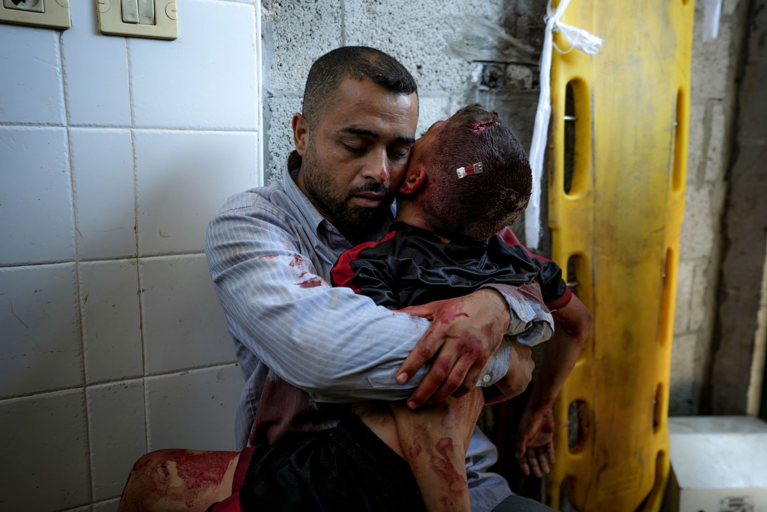 Nael Al-Baghdadi holds the body of his 12-year-old son, Omar, at a hospital morgue in Deir al-Balah, Gaza, on Tuesday, July 9. <a href="index.php?page=&url=https%3A%2F%2Fapnews.com%2Farticle%2Fisrael-palestinians-hamas-war-news-07-09-2024-5c8eb2a36e22fb0ea7666b73e5c0b54c" target="_blank">Omar was killed by an Israeli airstrike</a> that hit a school complex housing displaced people in southern Gaza. Local health officials said <a href="index.php?page=&url=https%3A%2F%2Fwww.cnn.com%2F2024%2F07%2F09%2Fmiddleeast%2Fisraeli-airstrike-school-khan-younis-intl-latam%2Findex.html">at least 27 people were killed in the strike</a>. The Israeli military said it conducted a strike “near” the Al-Awda school on Tuesday and that it had targeted “a terrorist” who participated in the October 7 attacks into southern Israel.