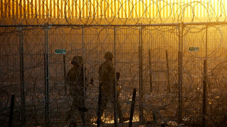 Members of the Texas National Guard stand guard near a razor wire fence to inhibit the crossing of migrants into the United States, seen from Ciudad Juarez, Mexico, June 4, 2024. REUTERS/Jose Luis Gonzalez