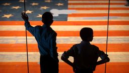 Children look at the Star Spangled Banner, the flag that inspired the lyrics of the American national anthem, at the Smithsonian's National Museum of American History, on June 10, 2025.