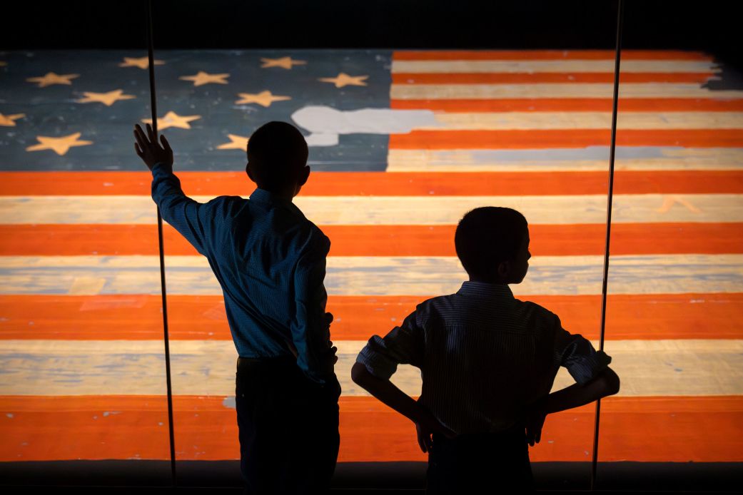 Children look at the Star Spangled Banner, the flag that inspired the lyrics of the American national anthem, at the Smithsonian's National Museum of American History, on June 10, 2025.