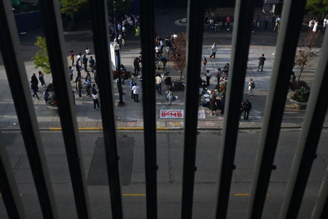 Convention attendees and pro-Palestinian protesters gather outside the United Center on Thursday.