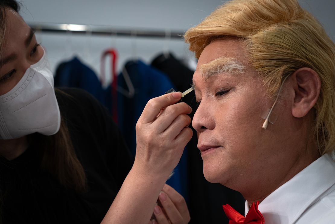 Loong gets his makeup done.