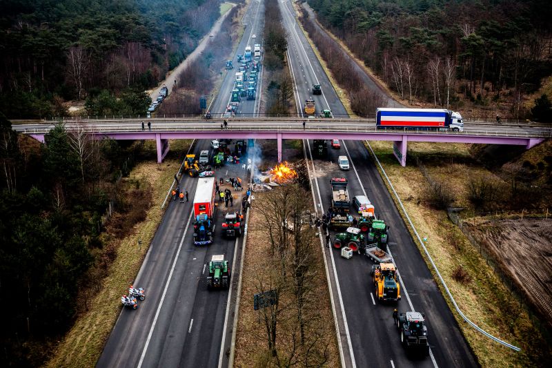 Dutch and Belgian farmers take part in a road blockade near the border crossing between Belgium and the Netherlands, in Arendonk.