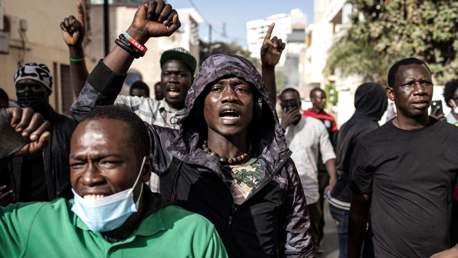 Protesters gesture after police fired teargas at them outside the General Assembly in Plateau, Dakar on February 5, 2024.