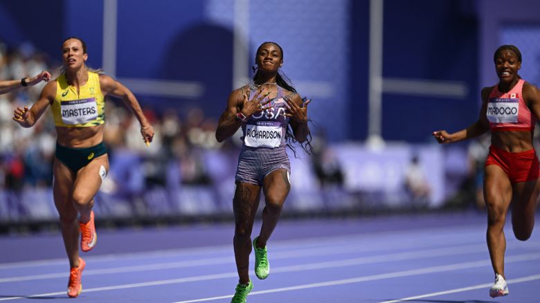 US' Sha'Carri Richardson (C) crosses the finish line to win past Australia's Bree Masters and Canada's Jacqueline Madogo in the women's 100m heat of the athletics event at the Paris 2024 Olympic Games at Stade de France in Saint-Denis, north of Paris, on August 2, 2024. (Photo by Jewel SAMAD / AFP)