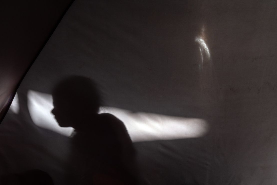 The shadow of a migrant is cast over a tent at Juventud 2000 shelter in Tijuana, Baja California state, Mexico, on November 6, 2024.