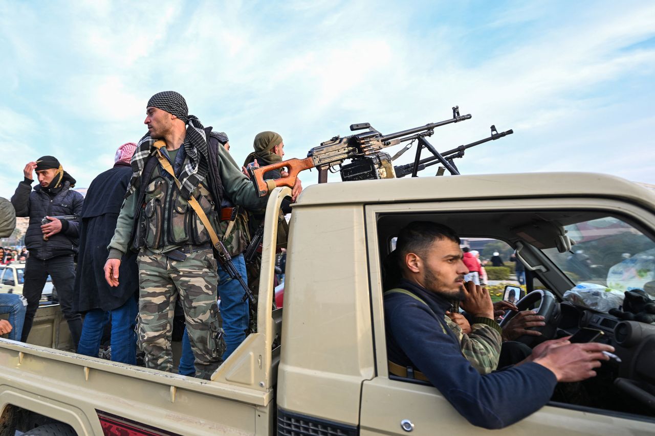 Rebel fighters arrive at Umayyad Square in Damascus.