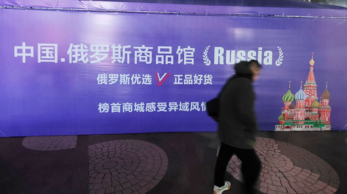 A man walks by a billboard promoting a shop selling Russian products in Shanghai on December 26.