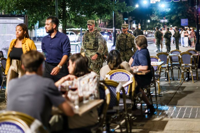 Members of the Ohio National Guard patrol near diners on 14th Street in Washington, DC, on August 23, 2025.