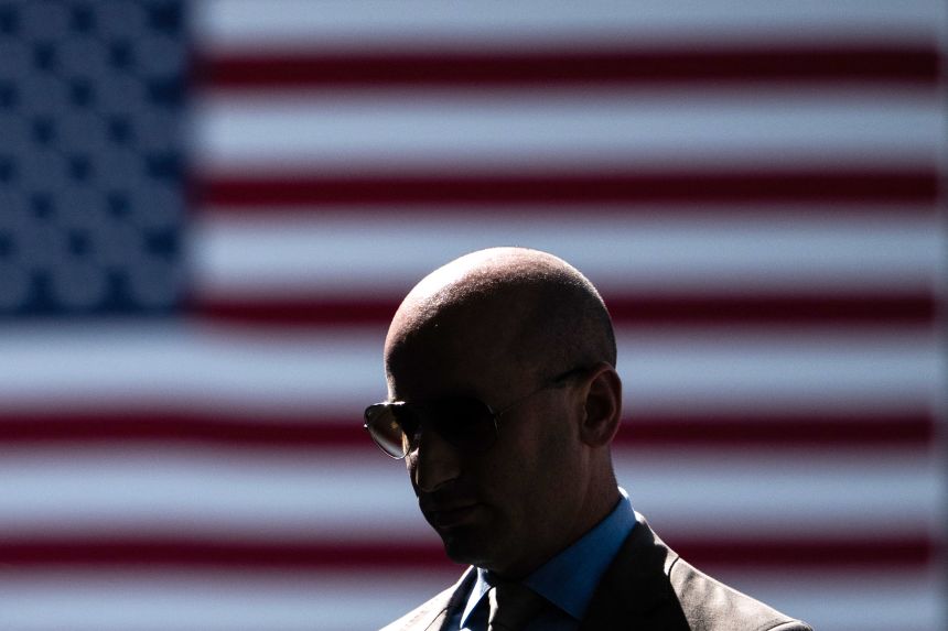 Miller walks to speak with members of the press outside the West Wing on August 29.