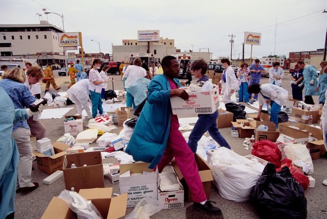 Relief workers carry boxes of medical supplies.