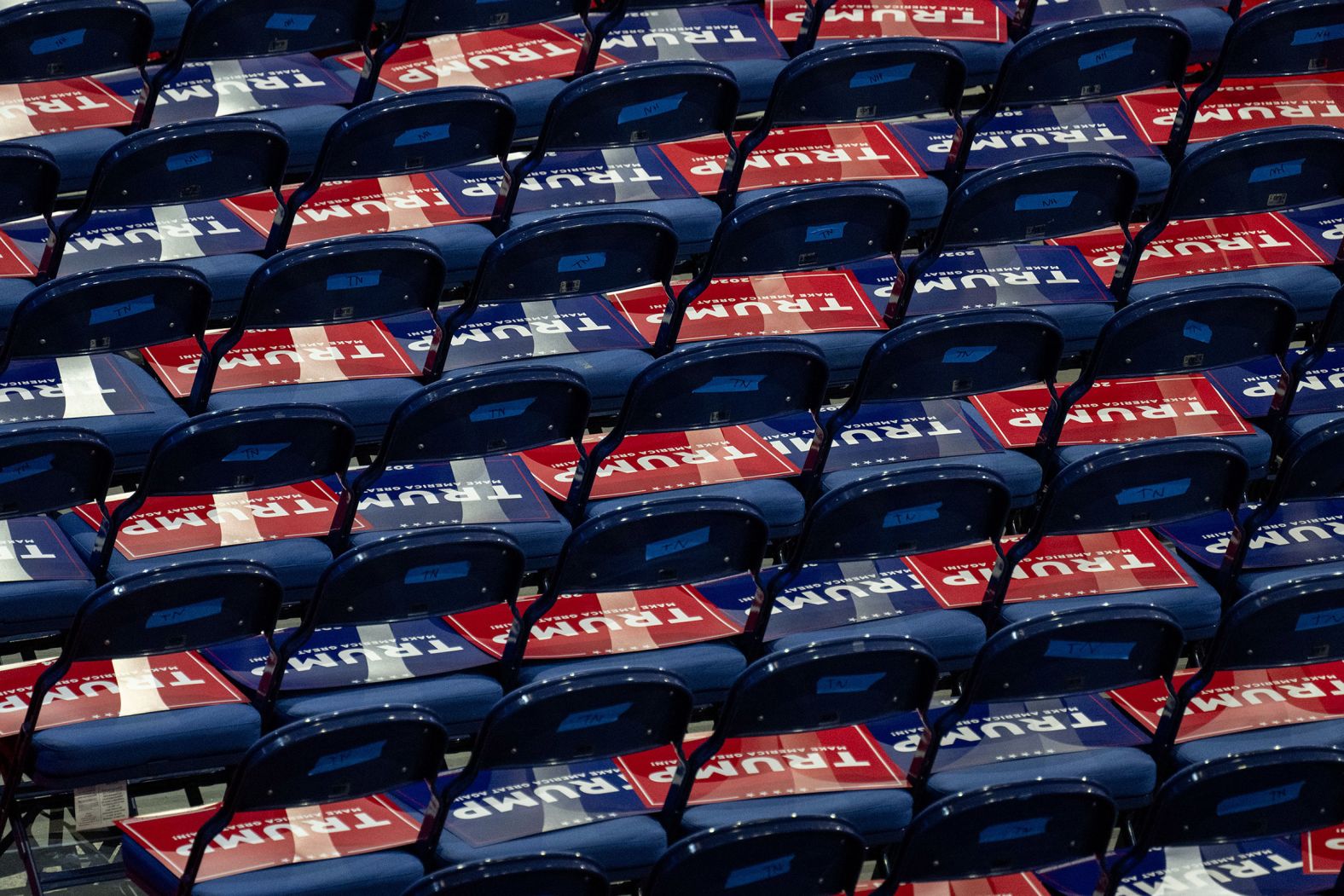 Trump signs are placed on seats ahead of Tuesday night's speakers.