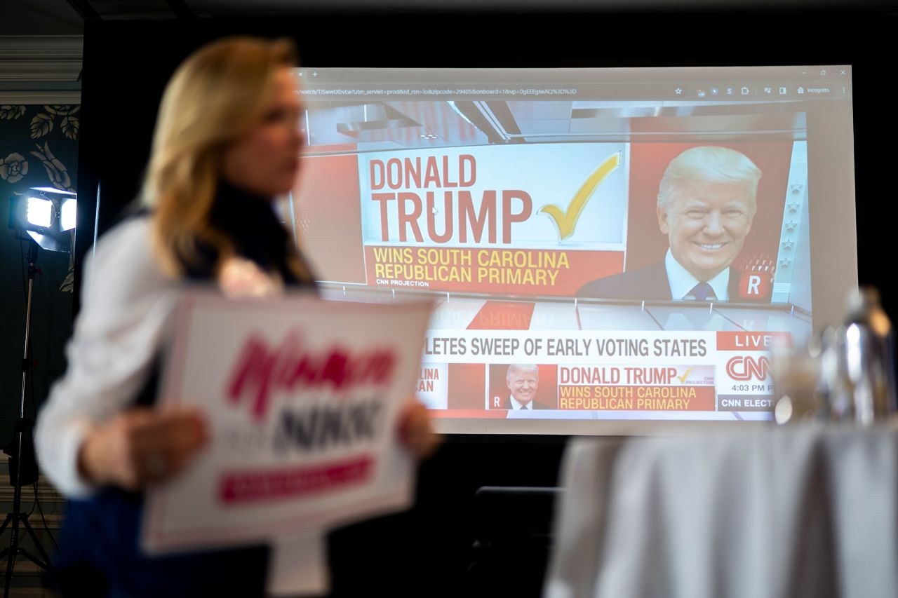 A woman holds a sign for Republican presidential candidate Nikki Haley as CNN declares Donald Trump the winner of the South Carolina Republican presidential primary on February 24, in Charleston, South Carolina. 