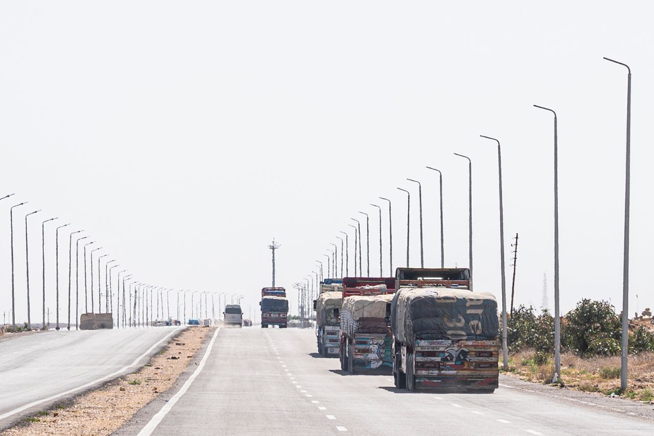 Aid trucks loaded with supplies for Gaza are waiting near the Egyptian-Palestinian border in preparation to enter Kerem Abu Salem crossing on May 26, in Rafah, Egypt.