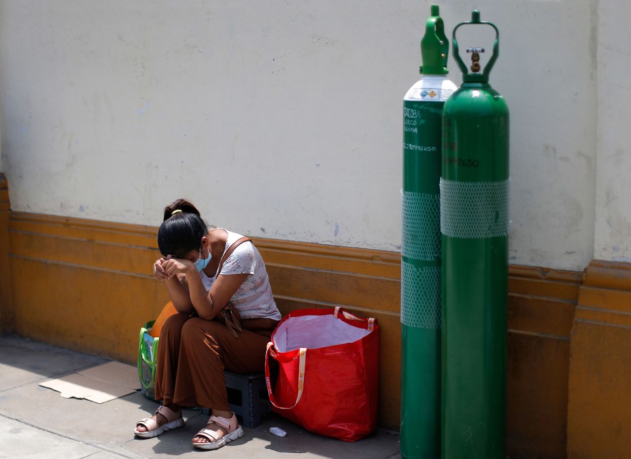 Relatives of Covid-19 victims queue to refill oxygen tanks, in Lima, Peru on February 9, 2021. 