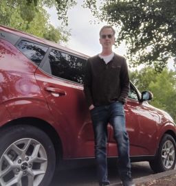 Greg Cook stands by his car, a 2022 Kia Soul, on July 18 in Oregon.