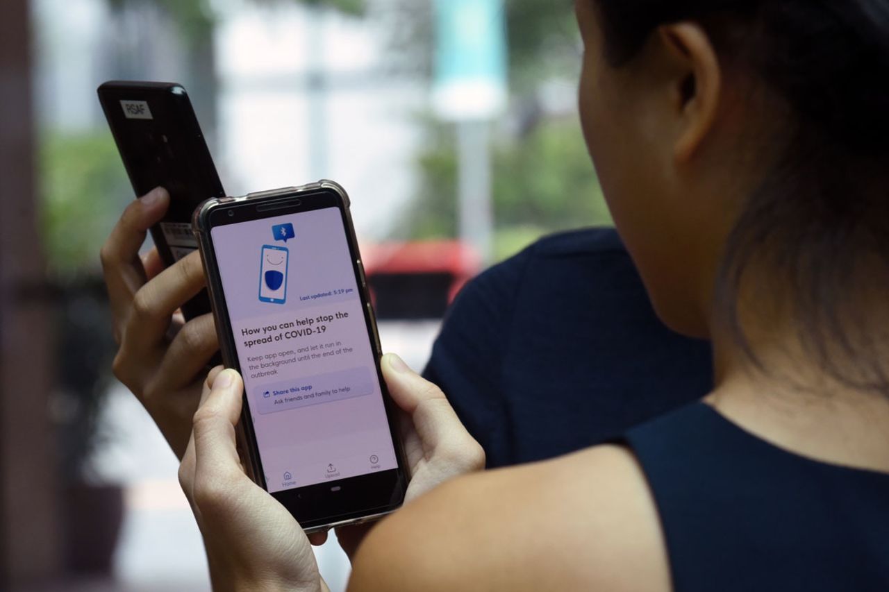 Government Technology Agency staff demonstrate Singapore's new contact-tracing smartphone app called TraceTogether, which was launched as a preventive measure against the novel coronavirus on March 20, 2020.